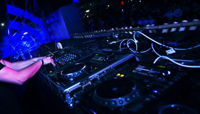 DJ Playing Music in Live Concert Festival